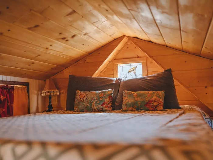 The stained glass window by the bed features a hummingbird, which was how the house got its name.