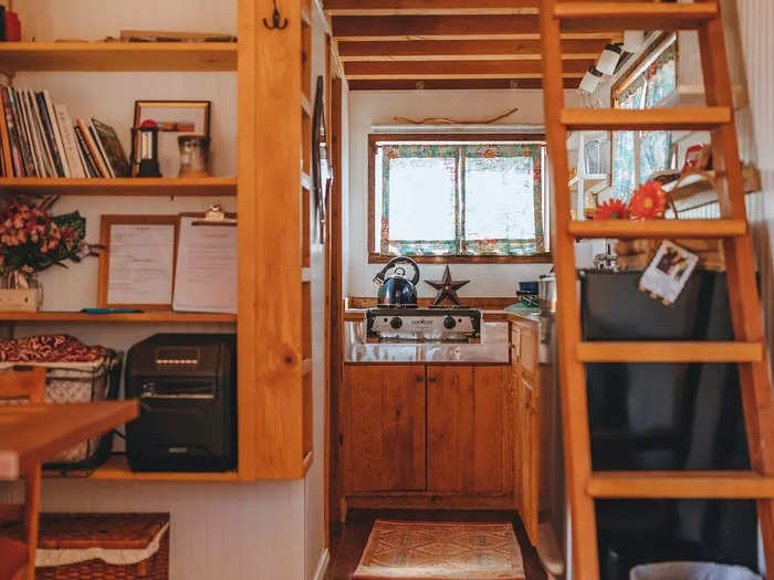 The table, cupboards, bed, and couch were custom made to fit the space.