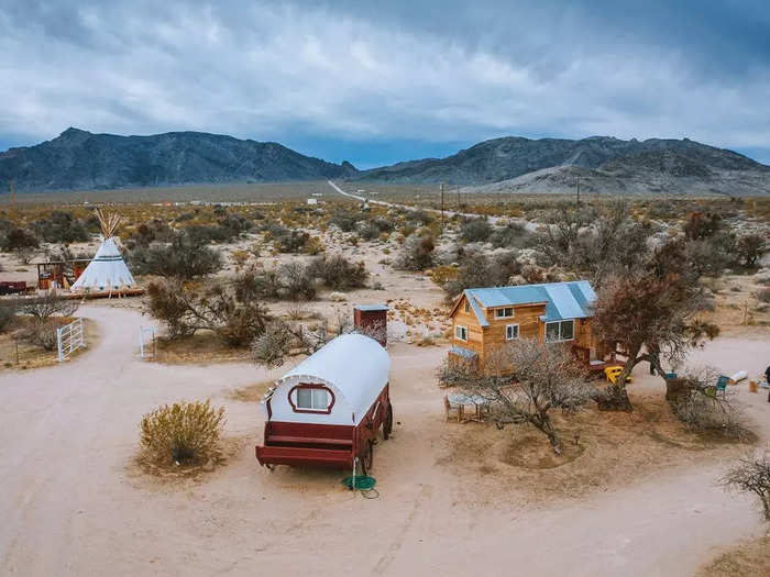 The Hummingbird House House is situated next to a Victorian-era red wagon.