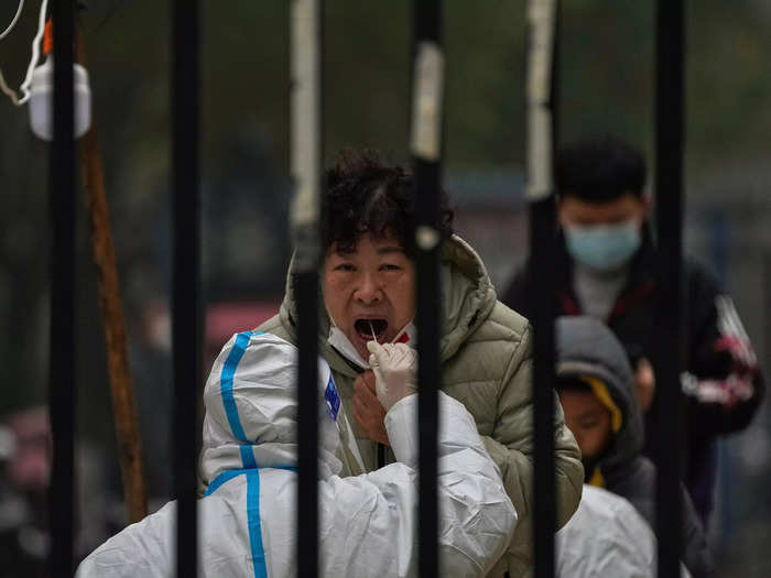 COVID-19 testing is also a routine practice in communities. In a Beijing residential compound, a woman receives a test.