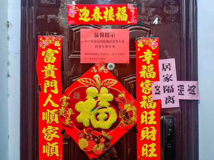 People who test positive and their close contacts are placed in quarantine at home or in a government facility which can include a hotel. In Anyang, Henan province, a seal is placed on the door of a residential community where people are in quarantine.