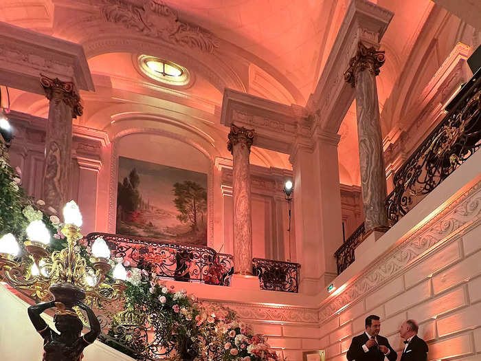 On the evening of Le Bal, floral decorations lined the grand marble staircase leading to the venue.