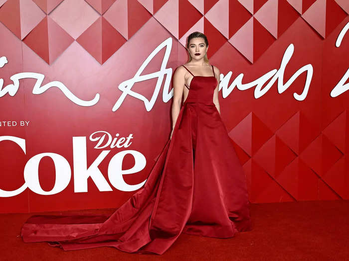 Florence Pugh arrived in a backless Valentino gown with side cutouts and a full skirt.