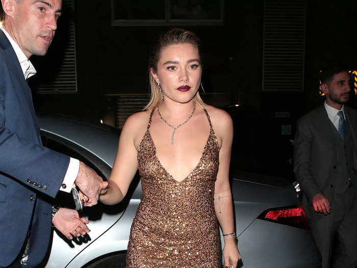 Florence Pugh stepped out in a custom Valentino gown embroidered with gold sequins after wearing a crimson gown by the same designer earlier that night.