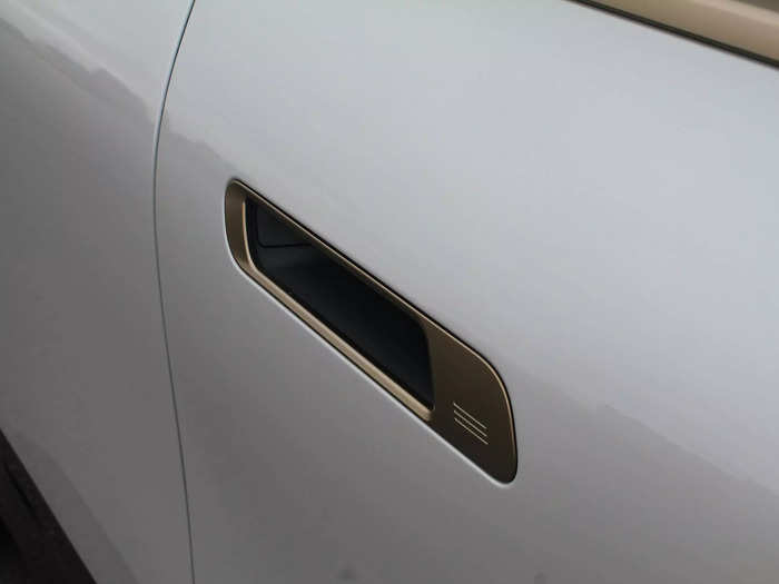 In place of standard door handles, you get sleek slots with a button inside.