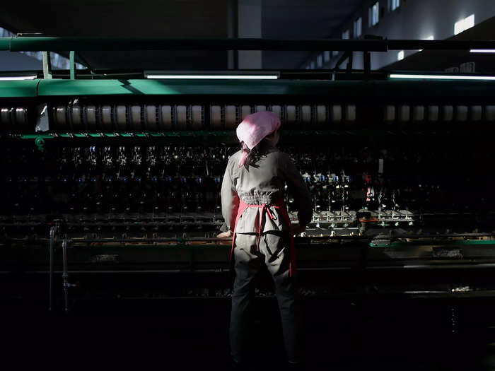 At the Suk Pyongyang textile factory, employees sort and process silkworms to produce silk threads.