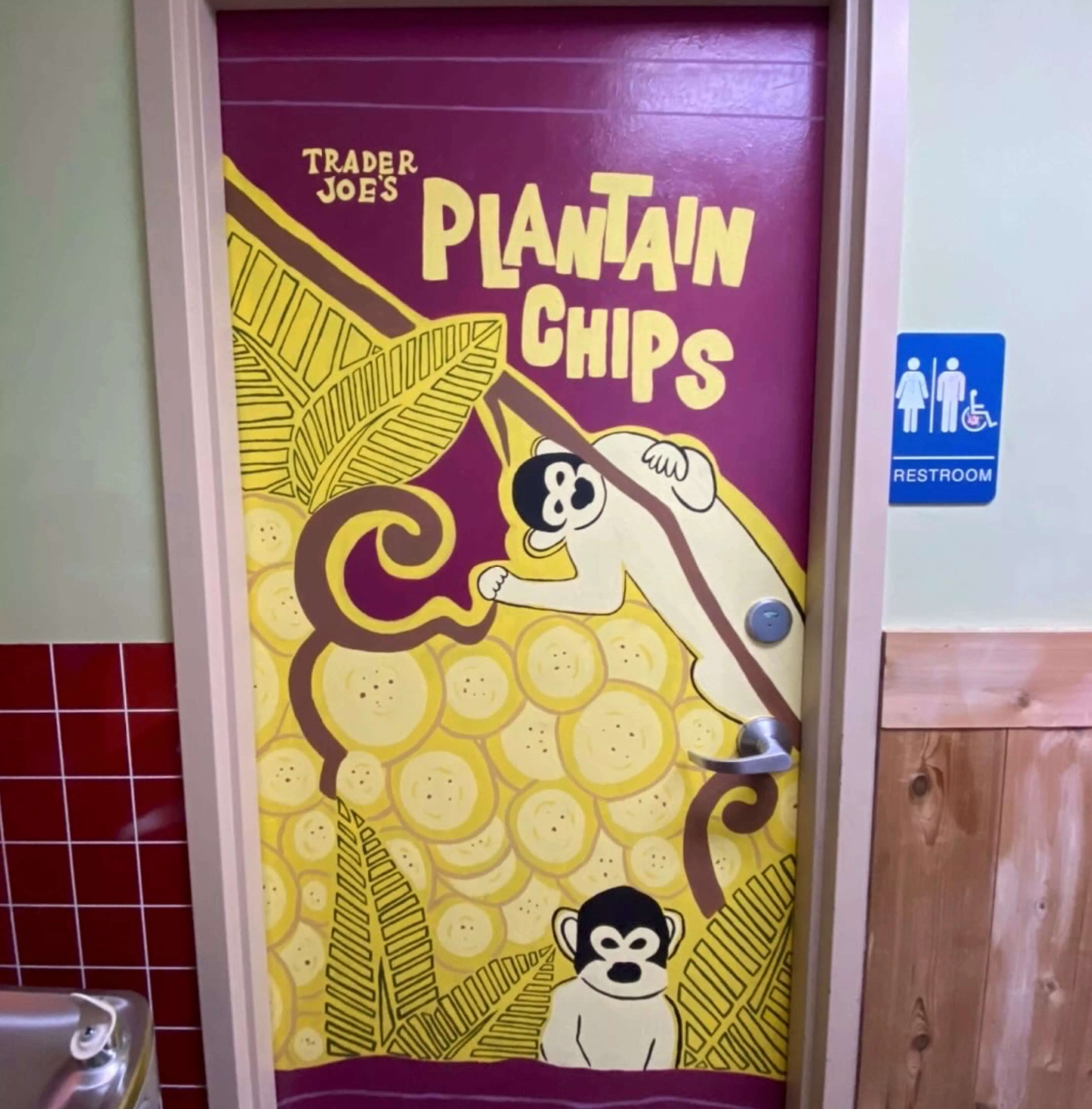 A bathroom door painted to advertise plantain chips.
