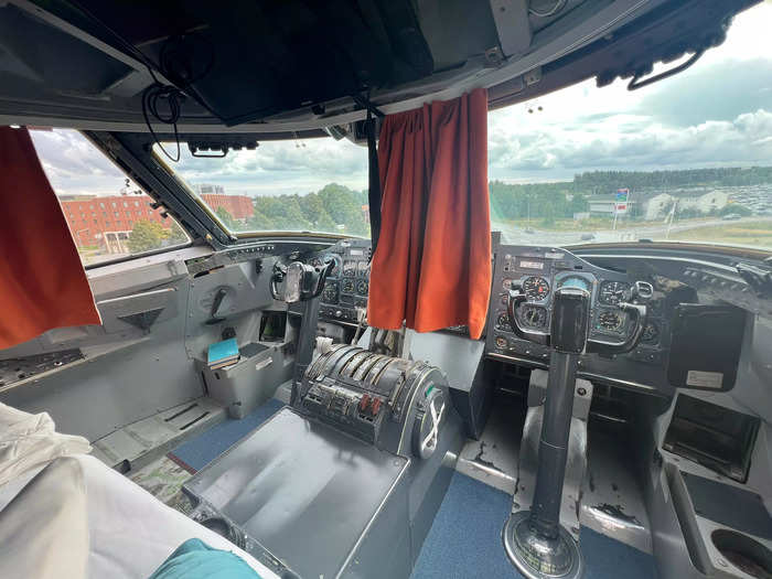 There is a double bed situated right in front of the cockpit, which still has its original flight controls and buttons…