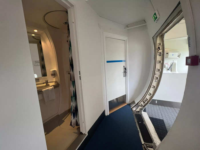 To get to these rooms, travelers must exit the plane, walk down the stairs, and around to the wheels. Then back up the stairs and inside to shower.