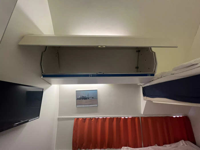 The single, double, and triple rooms inside the jet have a shared bathroom and shower and feature twin or bunk beds, as well as storage in the old overhead bins. I thought this was a cool touch.