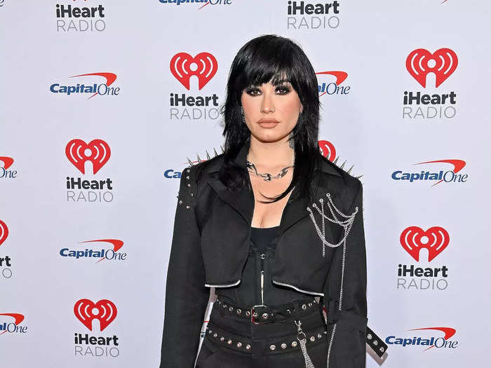 Demi Lovato posed on the red carpet in their stage outfit.