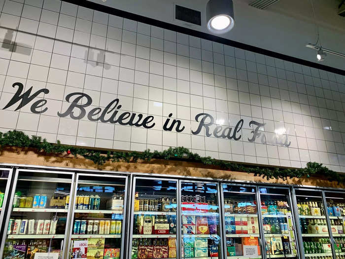 "We believe in real food" is painted on the wall above another refrigerated section, which reminded me of Wegmans