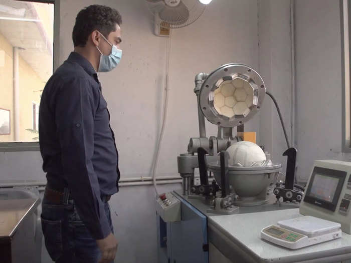 And this worker is using a thermobonding mechanism to put together a higher-end soccer ball. Balls made through this method have no stitching on the ball.