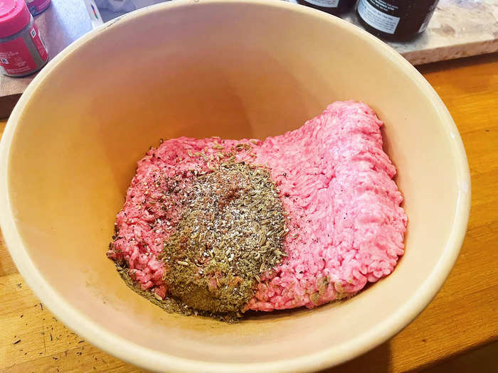 After preheating my oven to 400 degrees Fahrenheit, I emptied my package of ground pork into a large mixing bowl and added in the spices.