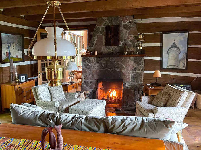 The living room has a traditional stone fireplace.