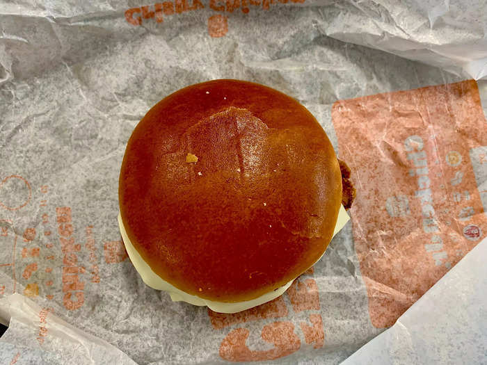 The sandwich comes on a shiny potato bun.