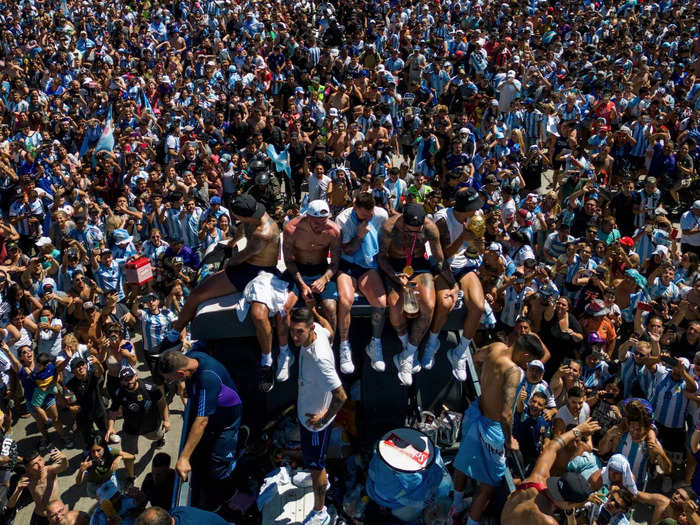 Lionel Messi can be seen here in the middle wearing a blue and white shirt at the back of the bus.