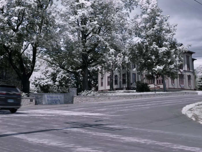 As Anna, James, and Gabriella enter Kentsbury, they pass by a large building, meant to be the town hall, with a sign that reads "Welcome to Kentsbury" in front.