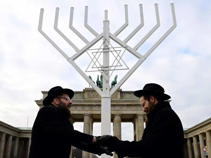 Hanukkah celebrations began in the city of Berlin as hundreds of people gathered at the historic Brandenburg Gate to witness the lighting of a giant 33-foot menorah. This is the largest of nearly 50 public menorahs placed throughout the city.