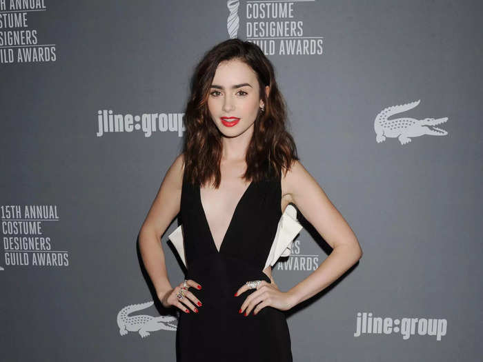 Lily Collins wore a sleek, floor-length gown with a plunging neckline to the 15th annual Costume Designers Guild Awards in February 2013.