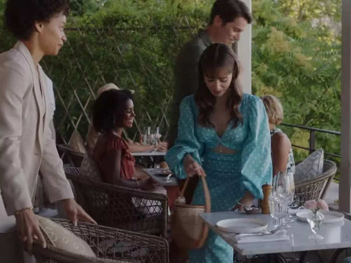 Emily sits on a stool for her purse instead of the chair clearly meant for her.