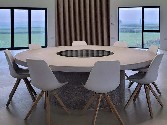 The dining area sits at the center of the highest floor. It was built over the original water tower access shaft, which can still be viewed through a glass panel in the middle of the table.