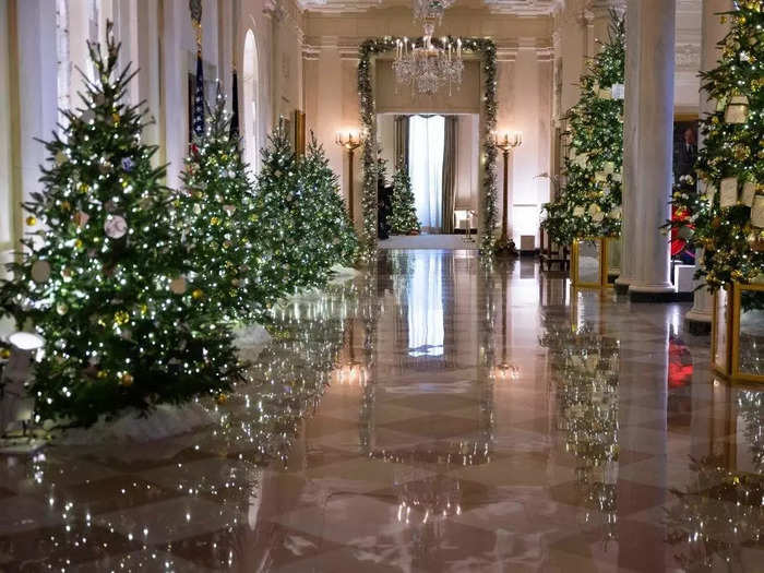 Trees and garlands accessorize the Cross Hall, which is on the first floor of the White House.