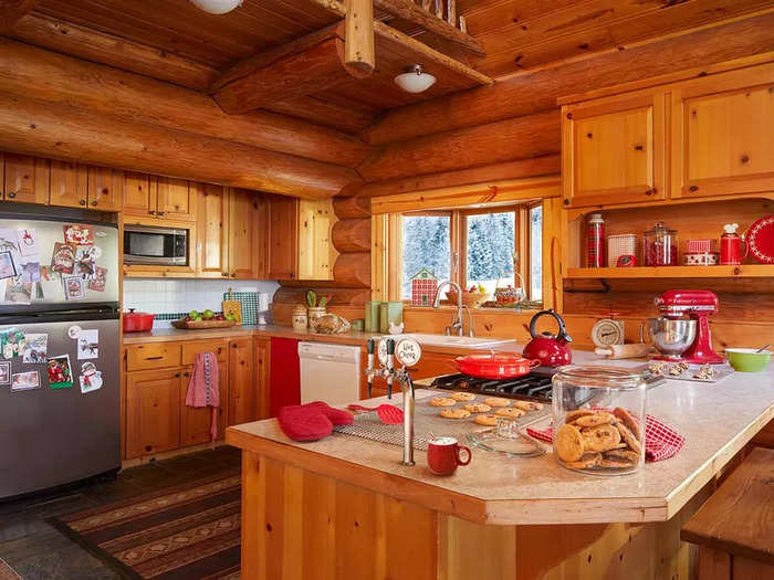 The kitchen has wooden cabinets and a fridge freezer. It even has a hot cocoa on tap.