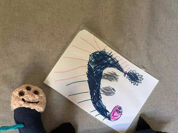 A drawing of a monster and the monster made into a toy that looks exactly like it