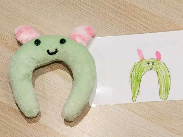 A drawing of a monster and the monster made into a toy that looks exactly like it