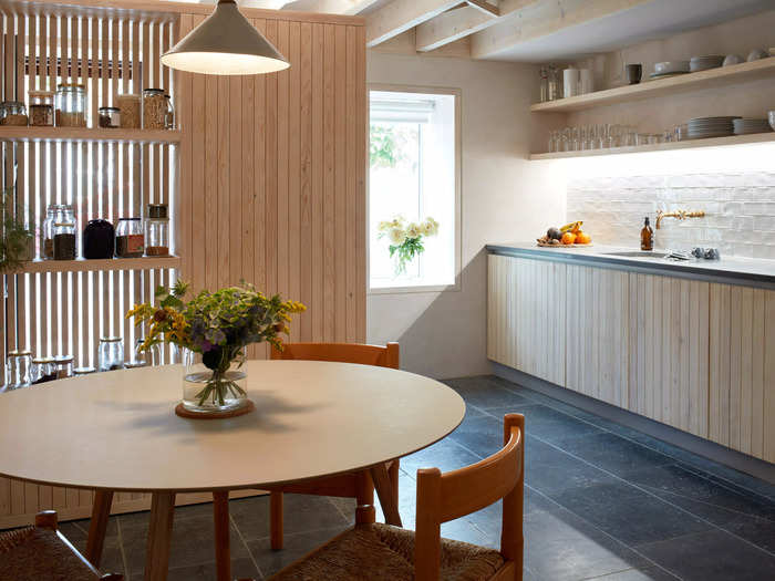 Relocating the stairs allowed the kitchen to be located at the front. Much of the interior is made from locally sourced wood, which was handcrafted by carpenters.