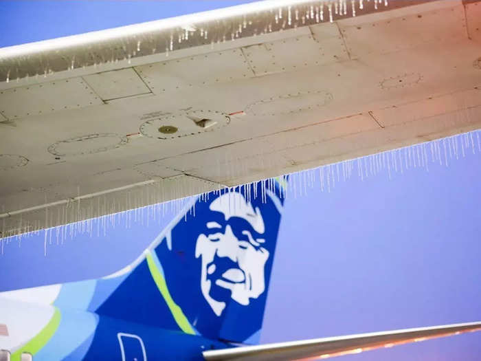 The freezing rain led to about 550 Alaska flight cancellations across the Pacific Northwest on Friday, with the airline posting pictures of icicles hanging from aircraft wings.