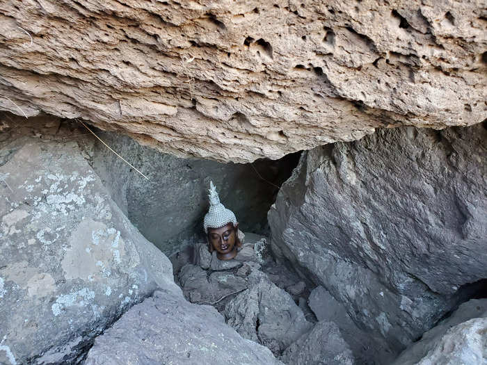 On the cliff overlooking the Crooked River and next to the Prayer Tree, I came across a Buddha statue hidden in a rock hollow.