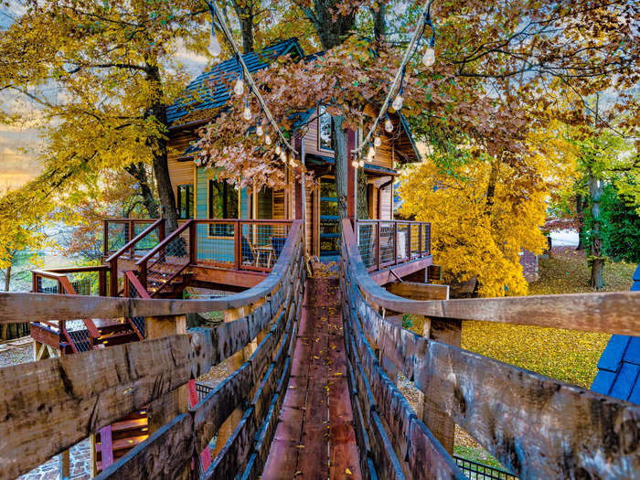 The treehouse is supported by four trees, and it