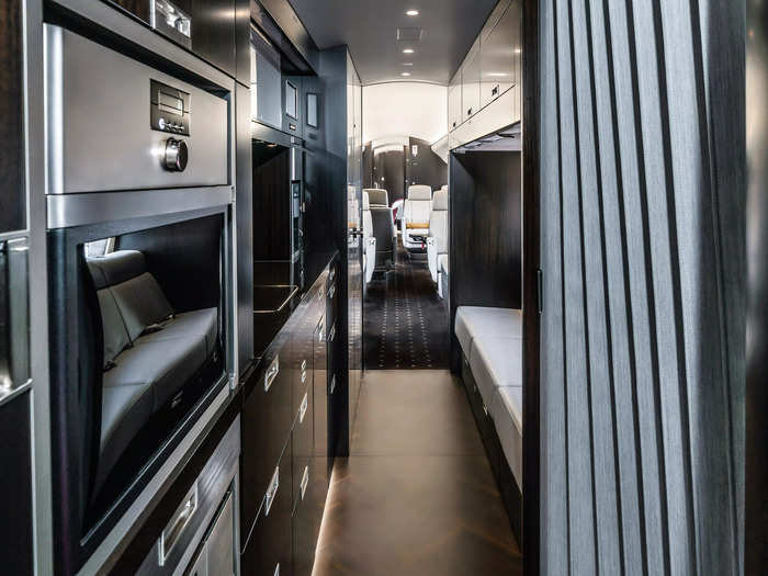 In addition to the main cabin, the front of the jet features the largest galley in private aviation, according to Bombardier, complete with glassware, two convection ovens, a coffee maker, and a refrigerator.