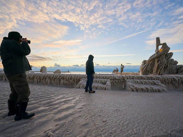 Once the storm subsided on Tuesday and roads began to be cleared, people ventured out into the winter wonderland to take photos of the ice-covered pier in Ontario.