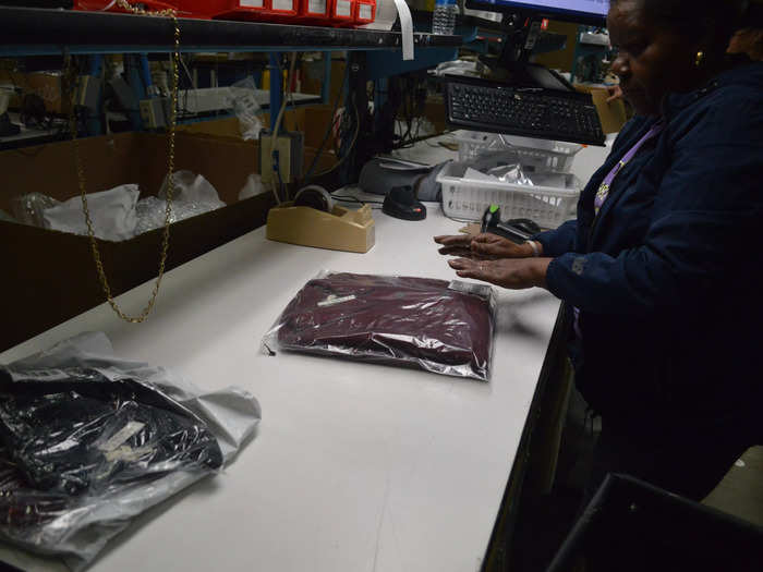 After an item of clothing is approved to go back into inventory, the worker repackages it to sell again. Each inspection takes minutes — or less, if nothing is amiss.