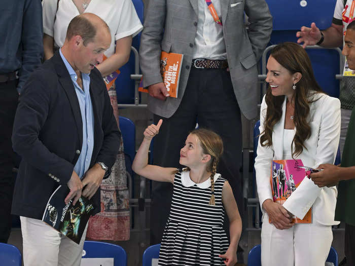 In August, Rooke photographed Charlotte giving a thumbs-up to William and Kate at the Commonwealth Games.