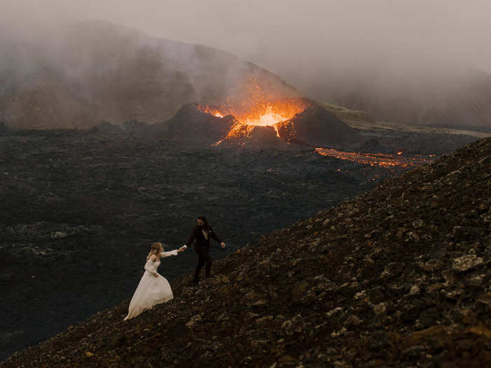 An adventurous couple took their wedding photos near an erupting volcano.