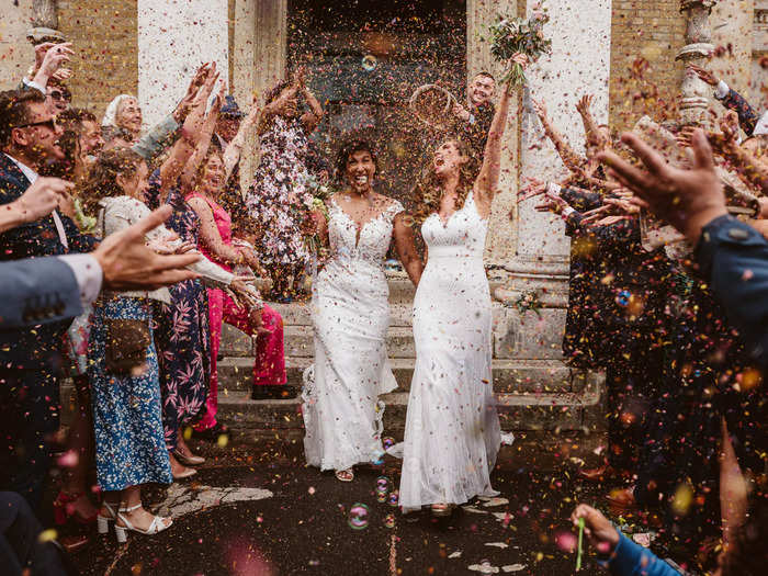 These two brides were showered with confetti and joy as they left their wedding service.