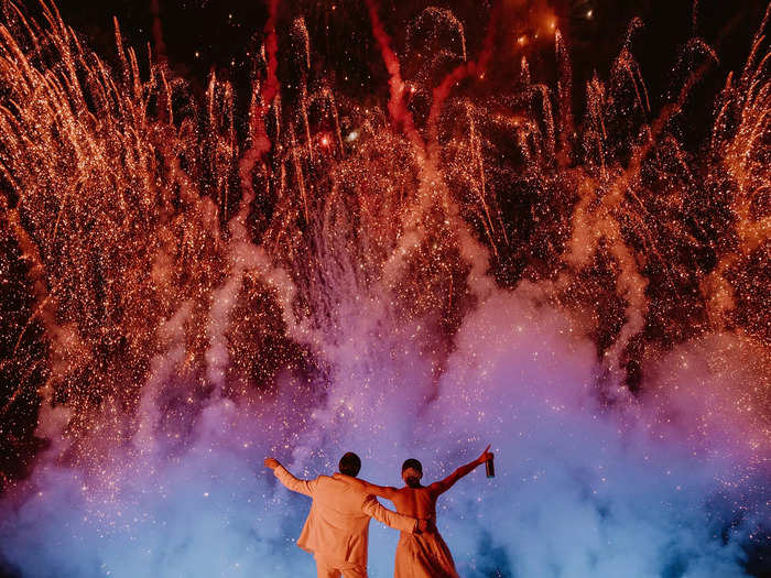 A photographer captured a bride and groom enjoying spectacular fireworks at their wedding.