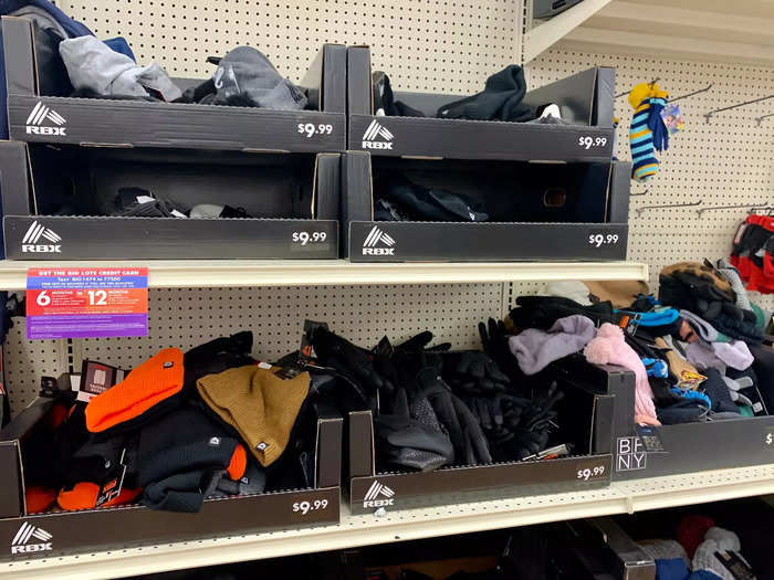 Messily arranged boxes of clothes lined shelves behind the tailgate setup.