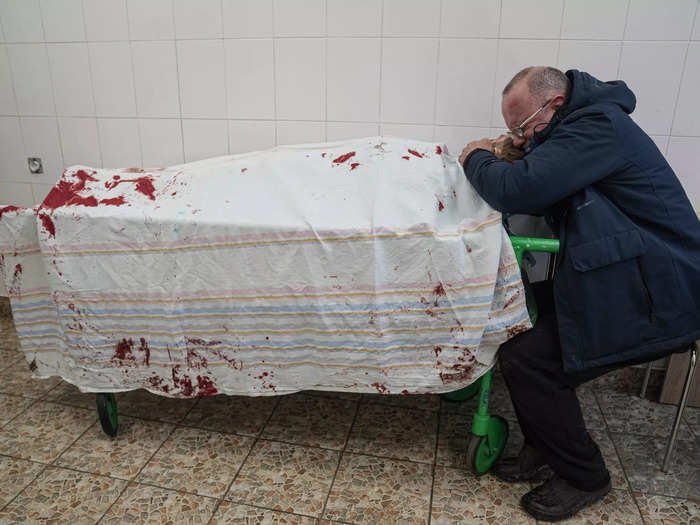 This heartbreaking photo, also taken in Mariupol, shows a father cradling the body of his teenage son who was killed by a Russian bomb.