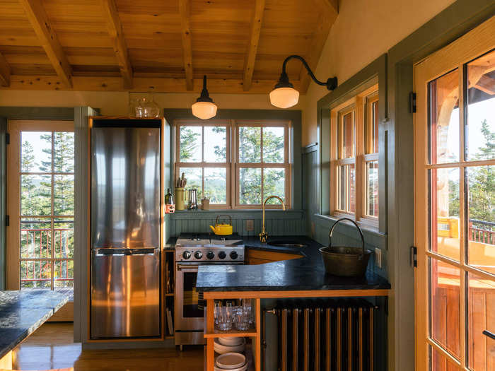 The kitchen includes an oven with a stovetop, a refrigerator, a sink, and ample counter space.