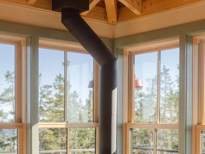 A wood stove sits on one end of the living room to provide extra warmth.