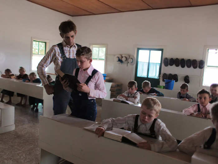 Mennonite children attend classes, where they study German, math, and religion.