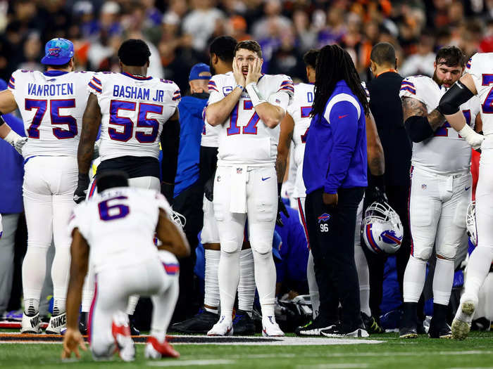 Medical staff rushed onto the field to treat the 24-year-old, whose teammates and opponents circled around him to shield him from the cameras and onlooking crowd.