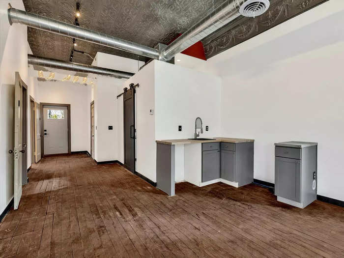 Inside, visitors will notice that the building went through a significant renovation, the listing states. The front entrance is home to a living space with an open kitchen area.