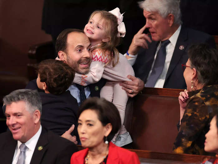 US Representative-elect Lance Gooden is spotted holding both of his children, Milla and Liam, inside the House during the 14th vote.