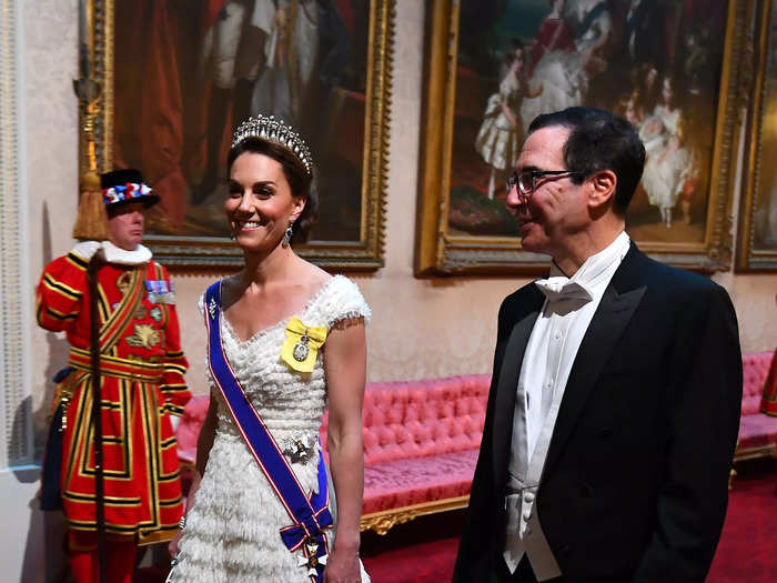 Kate wore a white cap-sleeve dress to a state banquet in 2019.